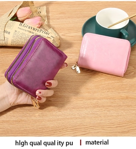 Detailed view of pink and purple PU leather RFID wallets with dual gold zippers