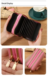 Detail display of pink leather RFID card holder featuring dual gold metal zippers