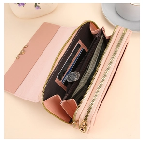 Detail of pink long wallet with multiple card slots and a central zipper coin pocket