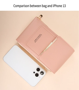 Detailed comparison of pink faux leather crossbody phone bag next to an iPhone 13