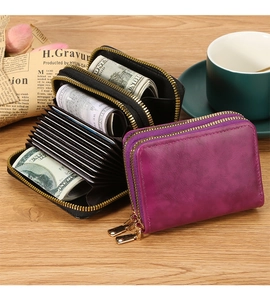 Detail of dual-zipper RFID card holder with accordion slots and vintage leather texture