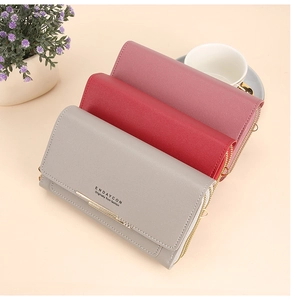 Trio of long zipper wallets in grey red and pink with metal decor and brand logo