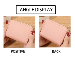 Detail view of pink leather card holder with dual gold zippers and accordion slots