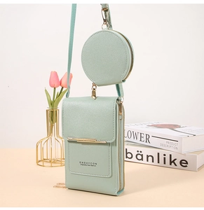 Detail of mint green crossbody phone bag with round coin purse and lychee leather texture