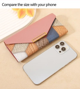 Detailed view of color-block patchwork long wallet with size comparison to a smartphone