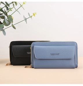 Close-up of black and light blue textured faux leather cross-body bags with gold zippers