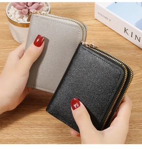 Close-up of double zipper accordion card holder in black and silver durable leather