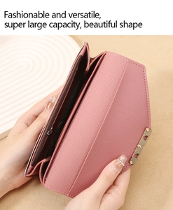 Detail view of pink long wallet showing internal zip compartment and heart metal trim