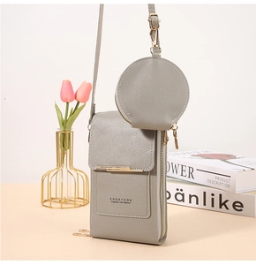 Detail of grey crossbody phone bag with litchi grain texture and gold hardware zipper