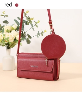 Detail of red crossbody phone bag with double zippers and detachable round coin purse