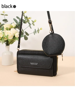 Close-up of black lychee grain crossbody phone bag with round coin purse and gold hardware
