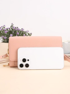 Pink long crossbody wallet bag in lychee leather texture with gold zipper and thin strap