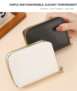 Detail of dual zipper card holders in black carbon fiber and smooth white leather finish