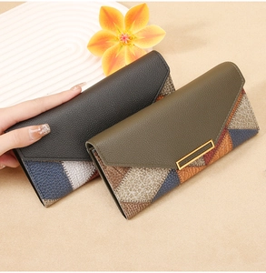 Macro shot of long envelope wallets with lychee pattern leather and gold metal bars