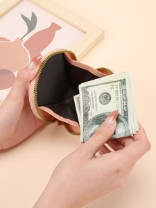 Porte-monnaie en cuir rose en forme de cœur avec fermeture éclair dorée et billets