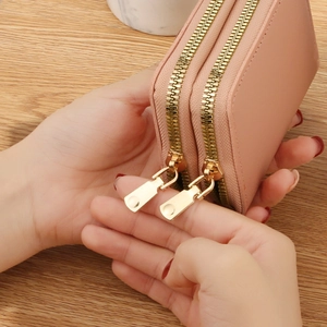 Light pink dual zipper leather card holder with large capacity and gold metal hardware