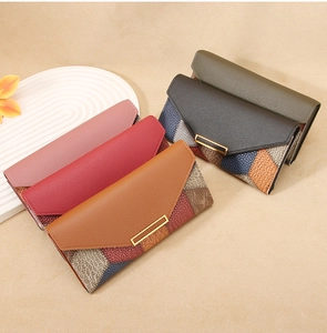 Multiple long leather wallets in various colors featuring metal buckle and pebble texture
