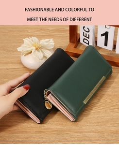 Detail of matte leather long wallets in black and dark green with gold metal accents