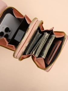 Pink crossbody phone bag with double zippers and interior card slots for organization