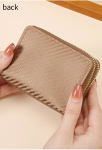 Close-up of light brown woven texture and precise stitching on dual-zipper card holder