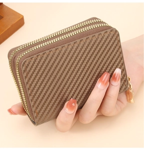 Detailed view of dark coffee carbon fiber texture wallet with dual gold zippers