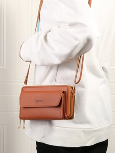 Brown leather crossbody phone bag with double zipper compartments and gold metal hardware