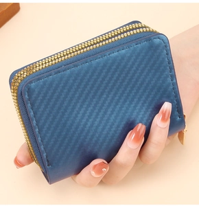 Detail of dark blue carbon fiber textured double zipper wallet with gold hardware