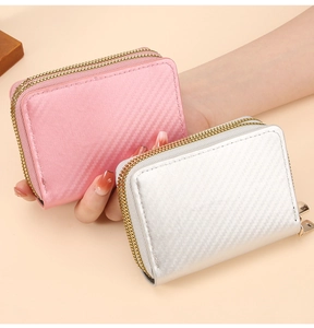 Handheld view of pink and silver carbon fiber texture wallets with double zipper design