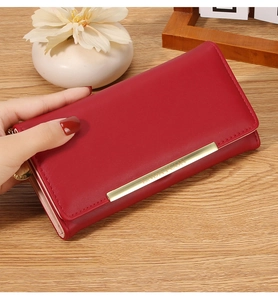 Detailed view of wine red PU leather long wallet with gold metallic bar and magnetic flap
