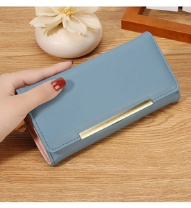 Detail of blue leather wallet showing golden logo bar and multi-layer inner structure