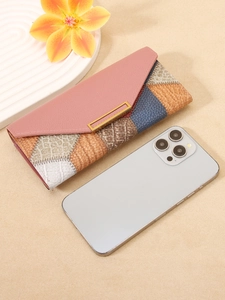 Modern patchwork long wallet with animal textures and gold accents in a flat lay view