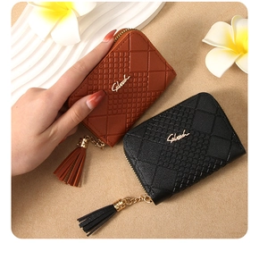 Detail of plaid embossed leather coin purses with elegant tassels and gold zippers