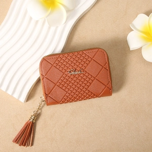 Detail view of brown faux leather wallet with grid embossing and fringe zipper pull
