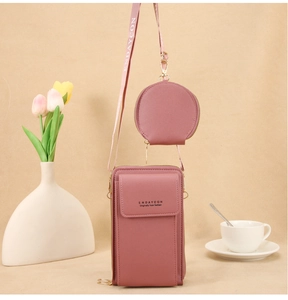 Detalle de bolso rosa para móvil de dos piezas con monedero redondo y correa tejida