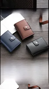 Detail showing RFID blocking carbon fiber wallets with automatic pop-up card mechanism