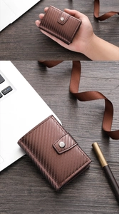 Close-up of brown carbon fiber texture wallet with secure metal snap button and fine stitching