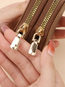 Brown dual-zipper accordion wallet featuring high-capacity compartments and gold hardware