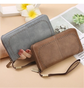Detail view of RFID blocking leather long wallets with hollow carvings and wristlet straps
