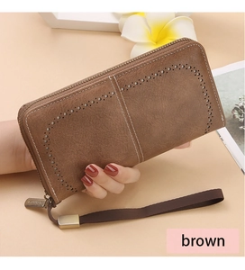 Detail view of brown RFID long wallet with hollow design, zipper, and wrist strap