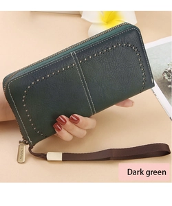 Detail of dark green RFID wallet with laser-cut hollow pattern and stitching
