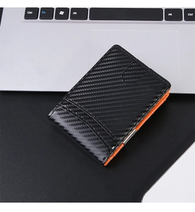 Detail of slim carbon fiber wallet with orange interior and stainless steel money clip