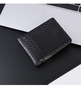 Detailed close-up of slim carbon fiber wallet with RFID protection on a silver laptop