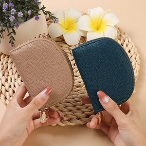 Close-up of semi-circle accordion card holders in beige and teal with lychee texture