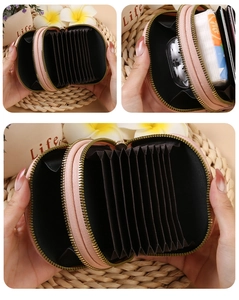 Pink PU leather accordion card holder showing internal slots and metal zipper detail