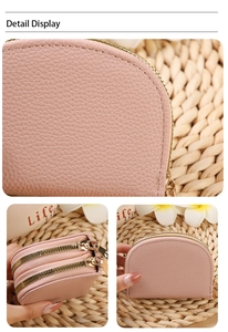 Detail display of pink litchi grain leather card holder with dual gold zippers