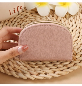 Detail of pink lychee leather half-round card holder with golden double zippers
