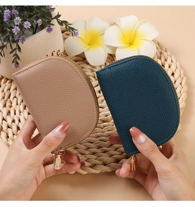 Detailed macro view of semi-circle accordion card holders in pebbled leather texture