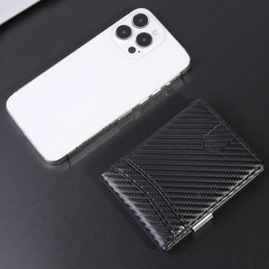 Slim carbon fiber RFID wallet with metal money clip and card slots on dark surface