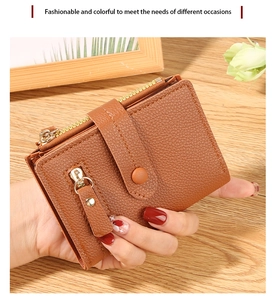 Brown litchi grain leather small wallet featuring gold zipper and snap closure detail