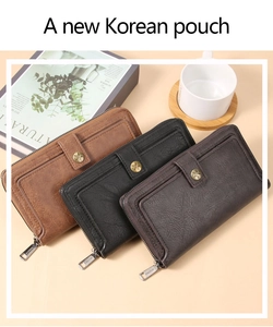 Detail of long leather wallets with lychee texture and star-shaped buckle closures